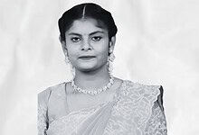 Black and white portrait of a woman in traditional attire with jewelry.