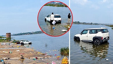 Car submerged in Krishna river with people nearby during flood in Telangana.