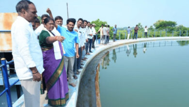 Officials and locals inspect Ramappa Lake during a site visit for water management.