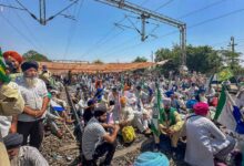 Farmers sit on railway tracks during a protest at the Shambhu border, in Patiala district,