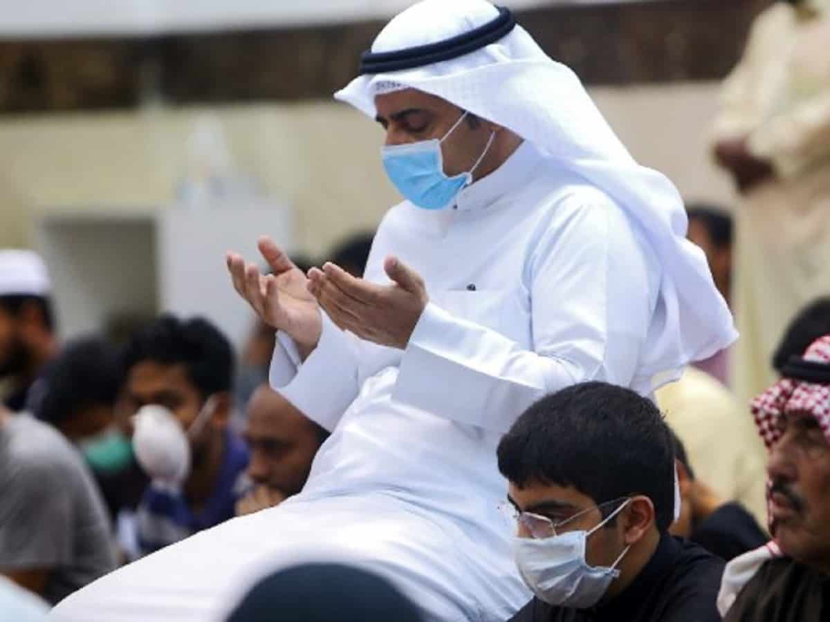 Muslim men wearing protective masks perform Friday prayers at a mosque in Kuwait City on February 28, 2020. - Kuwait's Ministry of Awqaf and Islamic Affairs set the Friday prayer sermon to not exceed 10 minutes, and to discuss precautions against COVID-19 coronavirus disease infections. Kuwait has recorded 43 coronavirus cases since its outbreak, the United Arab Emirates reported 13, while Bahrain has 33, and Oman is at four cases. Government institutions in the gulf country suspended the use of fingerprint recognition to clock in and out. (Photo by YASSER AL-ZAYYAT / AFP)