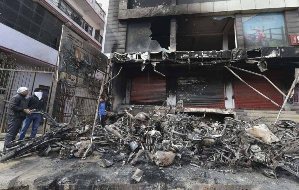 New Delhi: Charred remains of vehicles set ablaze by rioters during communal violence over the amended citizenship law, outside an auto showroom in Khajuri Khas of Northeast Delhi, Friday, Feb. 28, 2020. (PTI Photo/Manvender Vashist)