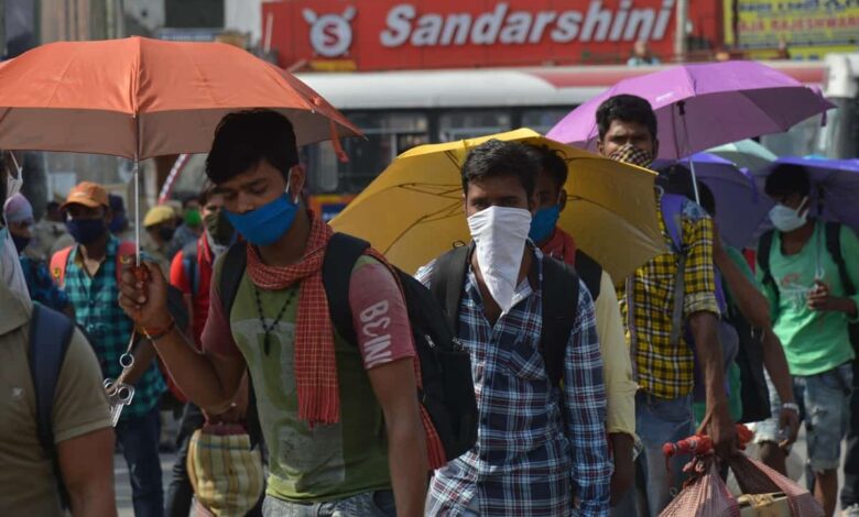As Hyderabad is witnessing alarming heatwave on Sunday the migrants who are waiting in queue at Secunderabad railway station to board Sharmik special trains to get to their home states seen holding umbrella to umberal protect themselves from sunlight. Photo: Mohammed Hussain
