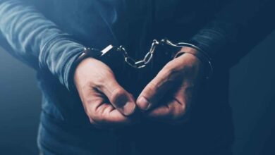 Arrested computer hacker with handcuffs
