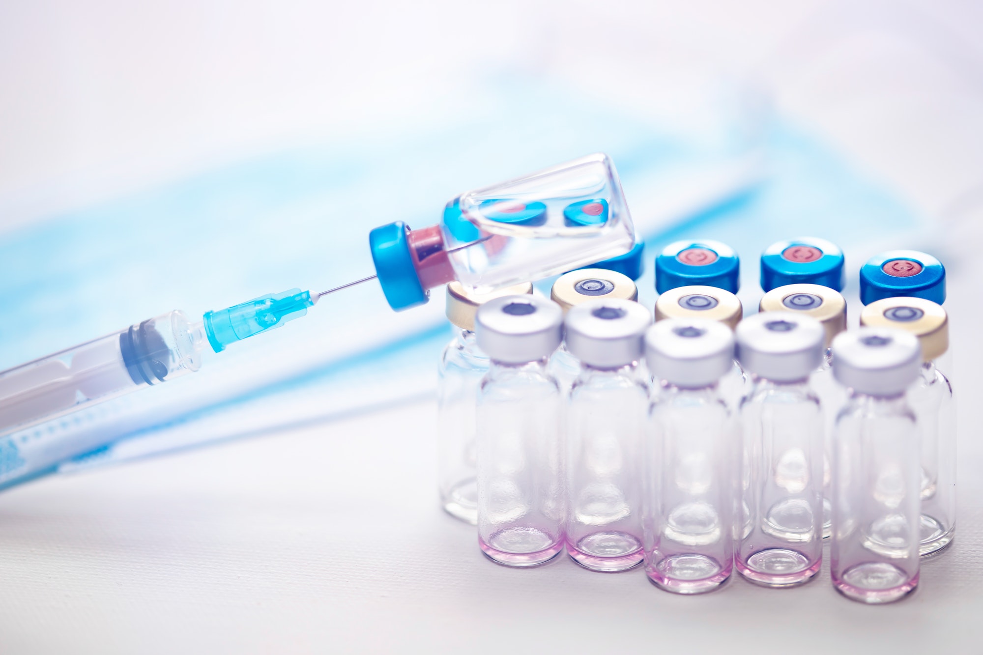 Close up on vaccine and medical syringe