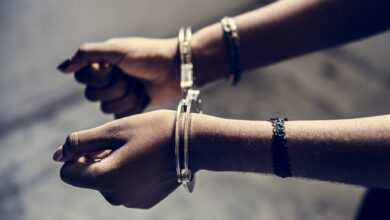 Closeup of arrested hands with handcuffs