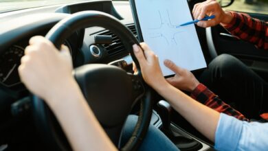 Woman and man with checklist, driving school