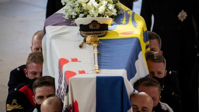 Prince Philip is laid to rest as somber queen sits alone