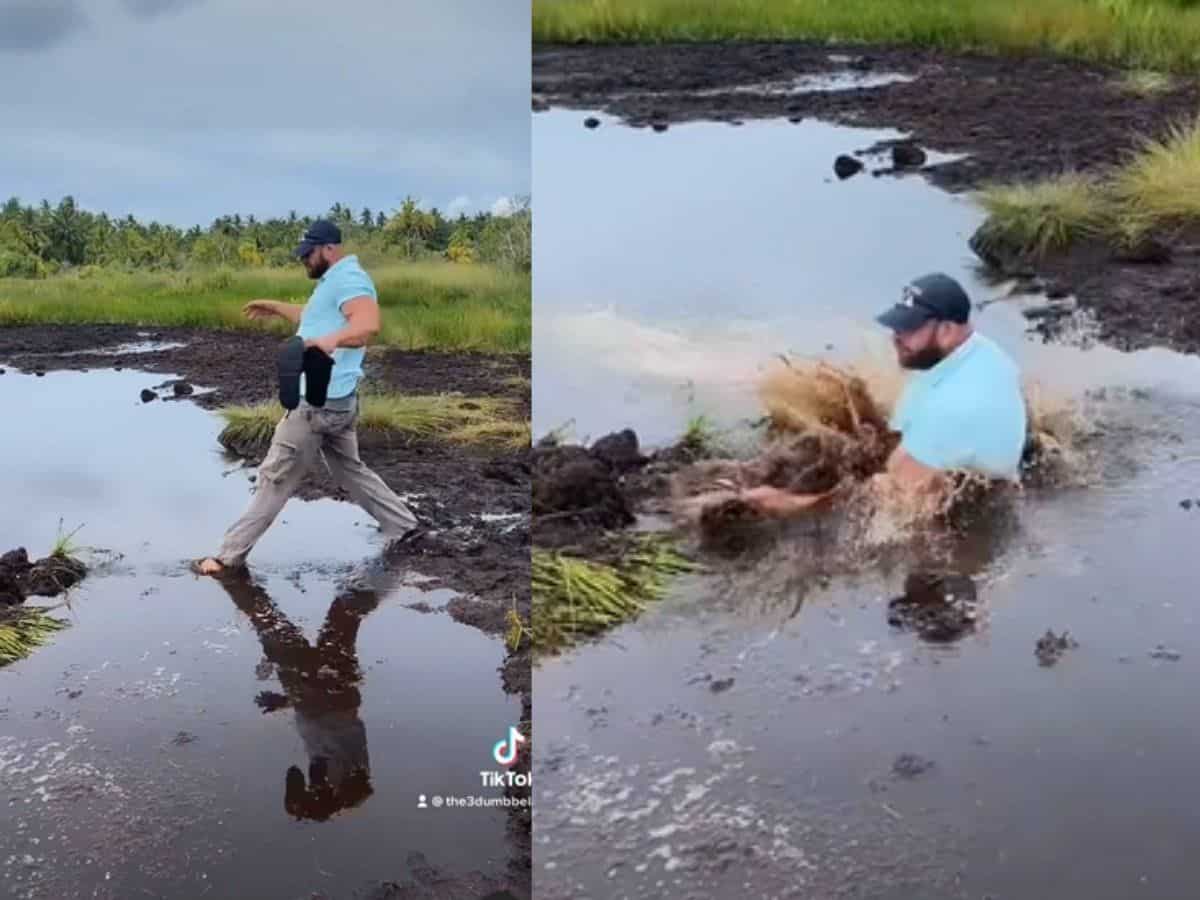 Tourist takes shortcut through muddy water; fails miserably (Video)