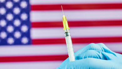 US hits 70% vaccination rate a month late, amid a surge