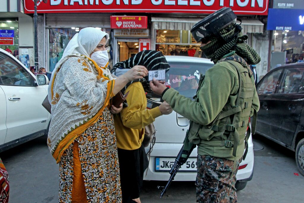 A Female CRPF personal checking Identity card of a women at Lal Chowk Srinagar, Security forces intensify frisking in srinagar after recent civilian killings in the valley