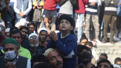 A kid making dua while he takes a glimpse of holy relic at Hazratbal Shrine in Srinagar