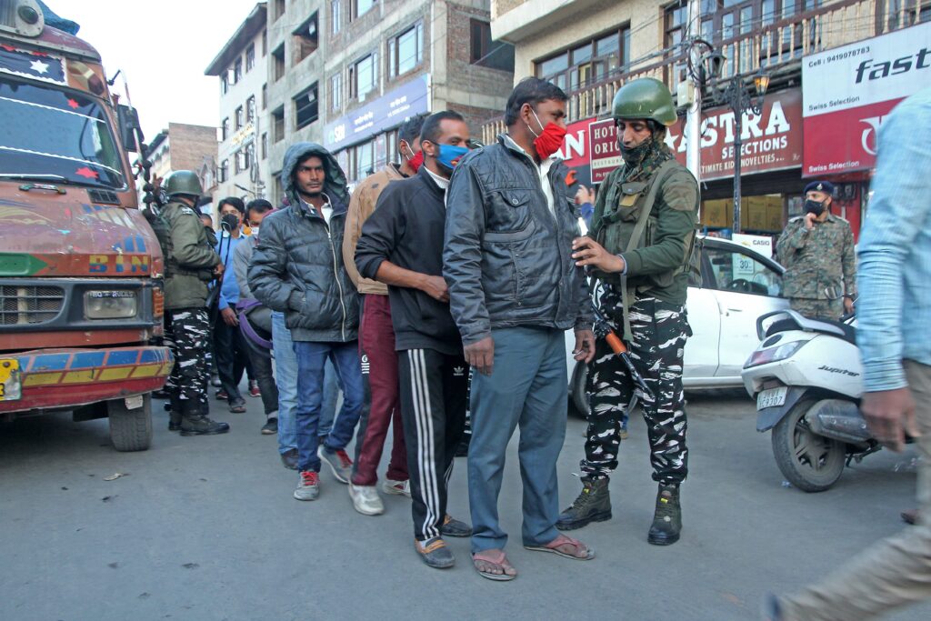Civiilans traveling in local buses lined up for frisking at Lal Chowk Srinagar, Security forces intensify frisking in srinagar after recent civilian killings in the valley