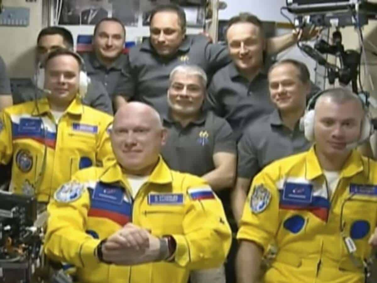 Russian cosmonauts arrive at space station in yellow and blue