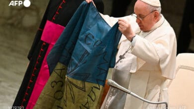 Pope Francis kisses Ukrainian flag from Bucha