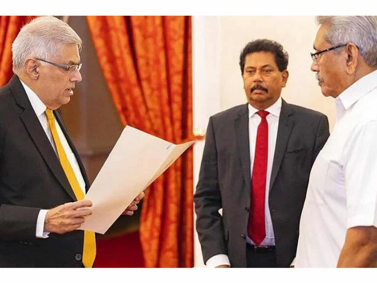 Sri Lankan President's Office, President Gotabaya Rajapaksa, right, watches Ranil Wickremesinghe take the oath of office as the new prime minister in Colombo, Sri Lanka