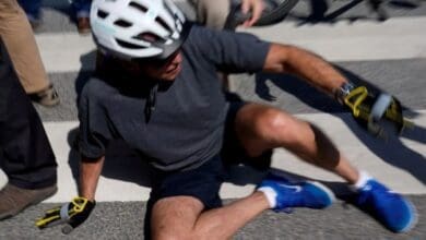US President Joe Biden falls off while riding his bicycle
