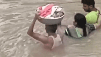 A toddler was rescued on a plastic tub carried on the head by a rescue worker