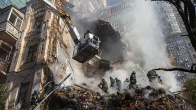 Firefighters work after a drone attack on buildings in Kyiv, Ukraine, on Oct. 17, 2022. The Iranian-made drones that Russia sent slamming into central Kyiv this week have produced hand-wringing and consternation in Israel, complicating the country’s balancing act between Russia and the West. (AP Photo/Roman Hrytsyna)