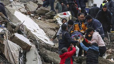 People and emergency teams rescue a person on a stretcher from a collapsed building in Adana, Turkey, Monday, Feb. 6, 2023. (Photo: AP)