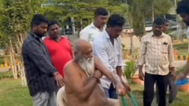 Andhra municipal chairman takes bath in front of office