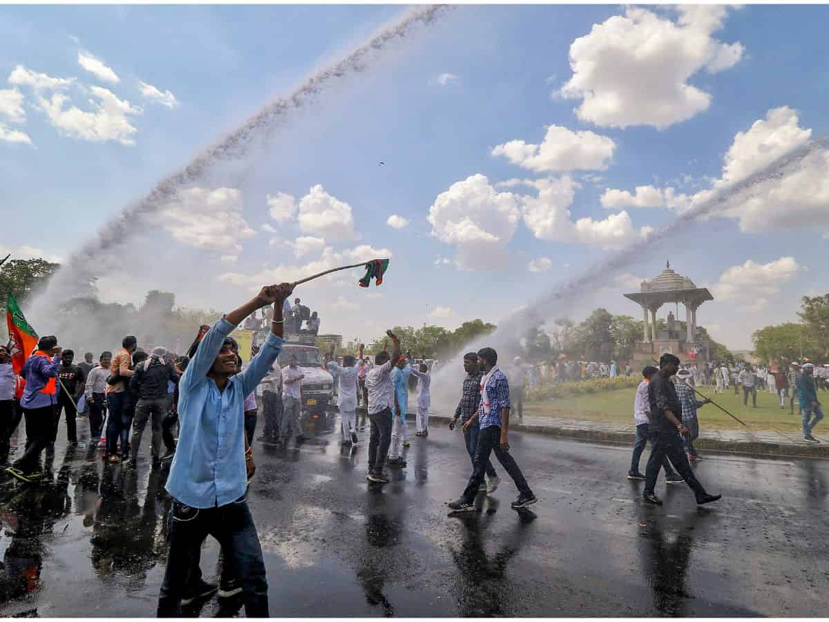 Jaipur: Police use water cannons to disperse the BJP supporters during their protest against the Rajasthan government, at Statue Circle near Secretariat office in Jaipur, Tuesday, June 13, 2023. (PTI Photo) (PTI06_13_2023_000207B)