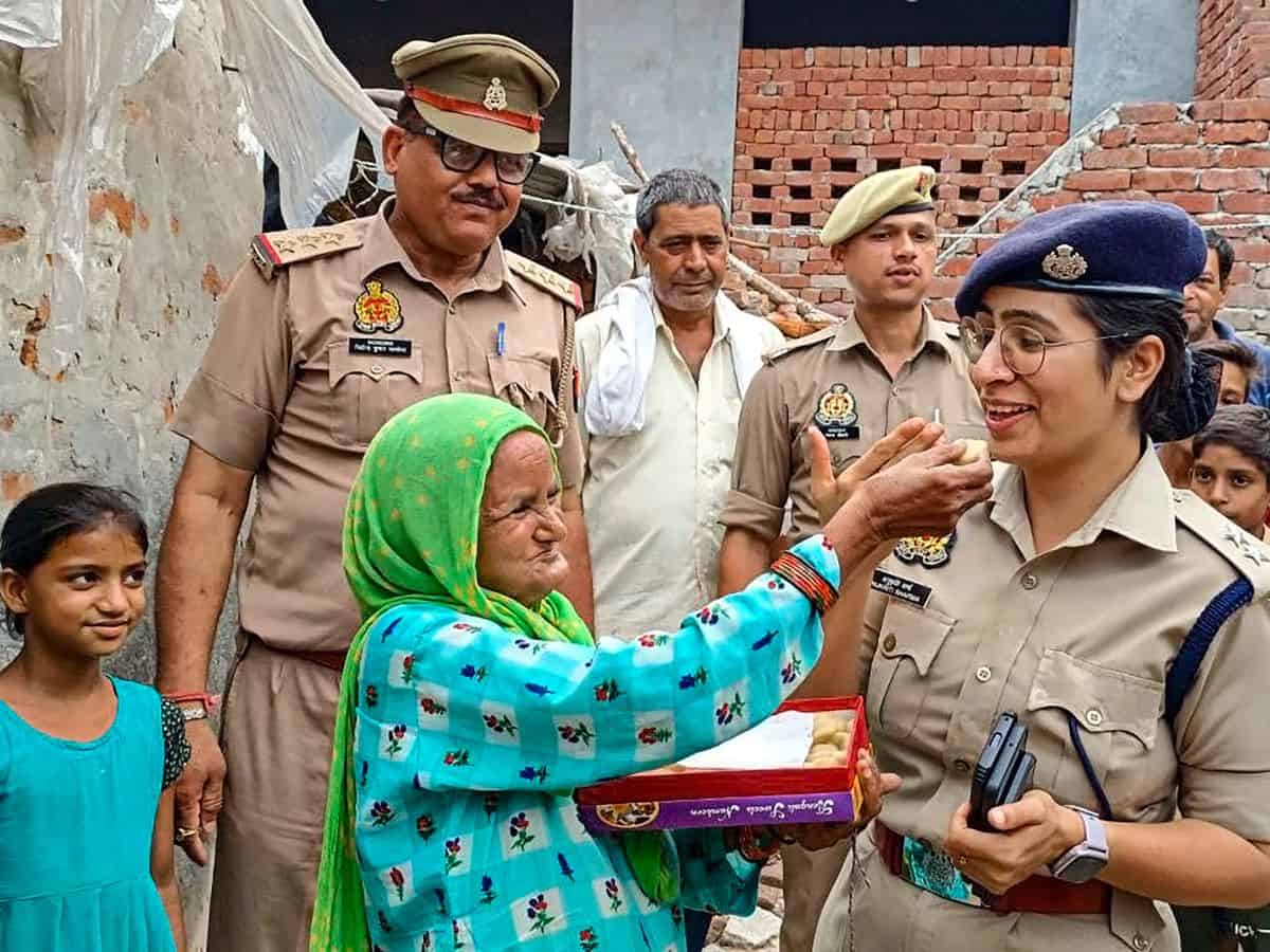 SP Bulandshahr Anukriti Sharma with an elderly woman Noorjahan after the former got electricity connection installed at the latter’s house, in Bulandshahr,