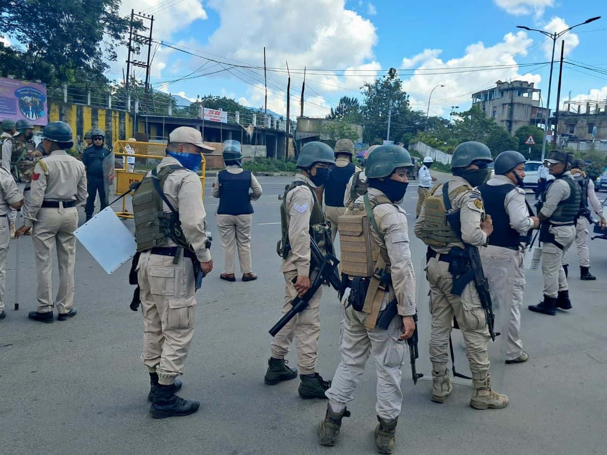 Security personnel stand guard during a protest rally by school students against the killing of two Meitei youth by suspected Kuki Zo militants in Imphal on Wednesday (PTI Photo)