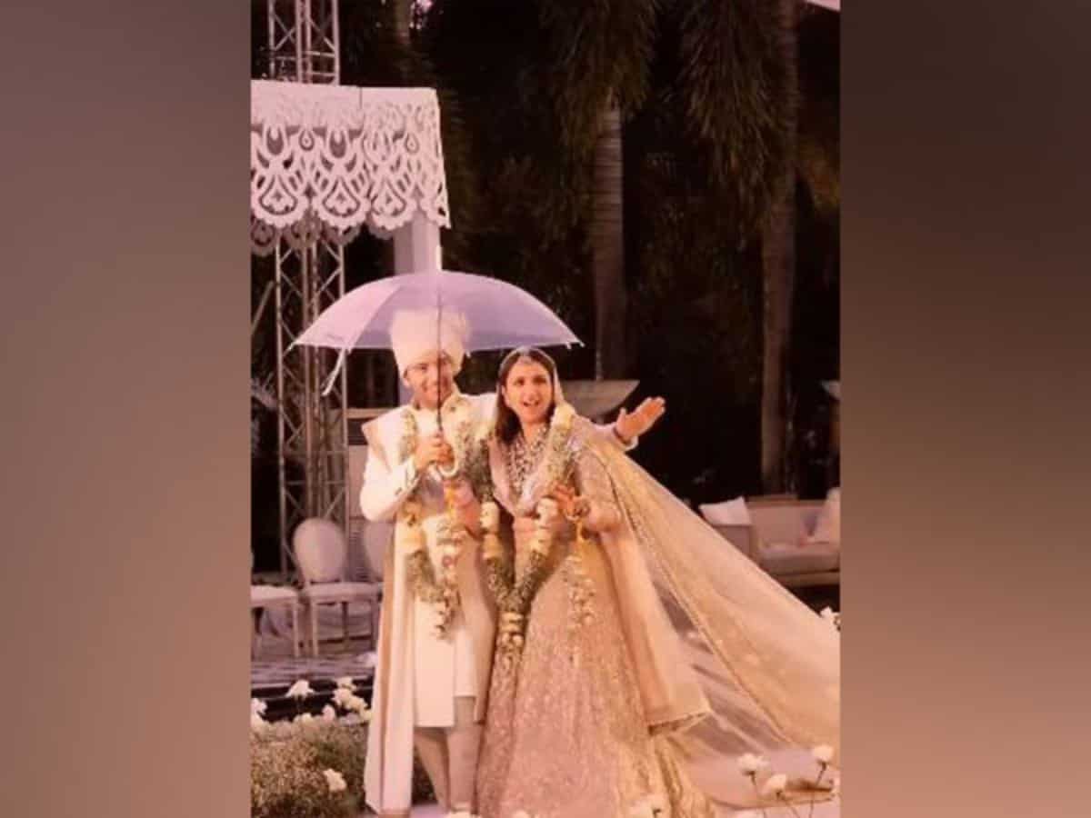 Parineeti, Raghav groove under umbrella as they walk down aisle