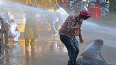 Police use water cannon to disperse AAP workers protesting against the arrest of party leader Sanjay Singh