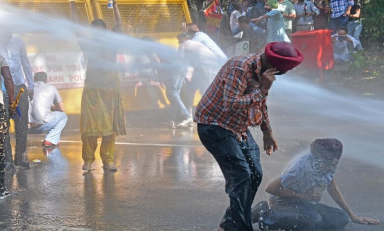 Police use water cannon to disperse AAP workers protesting against the arrest of party leader Sanjay Singh