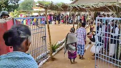 **EDS: GRAB VIA PTI VIDEO** Kanker: Voters being welcomed as they arrive to cast their votes for the 1st phase of Chhattisgarh Assembly elections, at a polling station in Kanker district, Tuesday, Nov. 7, 2023. (PTI Photo)(PTI11_07_2023_000069B)