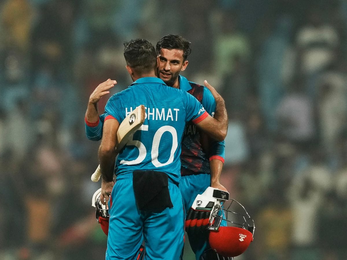 Afghanistan's batters Hashmatullah Shahidi and Azmatullah Omarzai celebrate after winning the ICC Men's Cricket World Cup 2023 match against Netherlands,