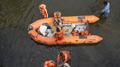 Chennai: NDRF personnel distribute food and other items amid floods after heavy rainfall in the aftermath of Cyclone Michaung, in Chennai, Thursday, Dec. 7, 2023. (PTI Photo/ R Senthilkumar)