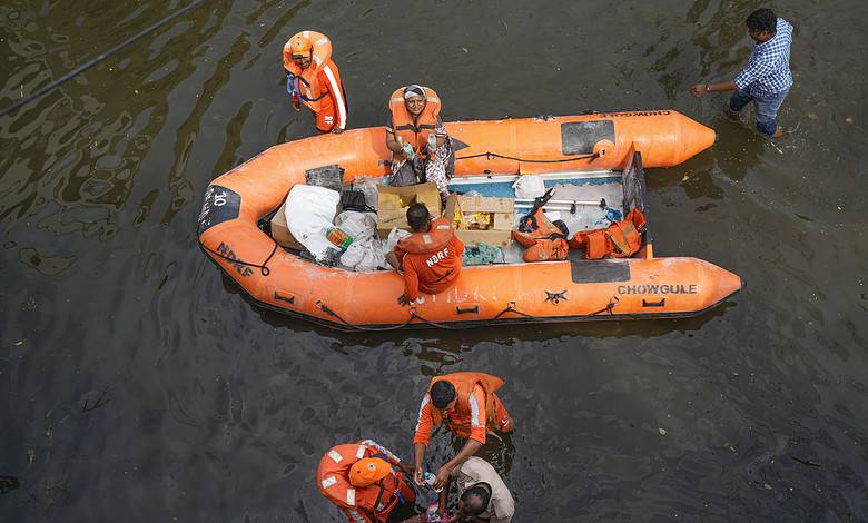 Chennai: NDRF personnel distribute food and other items amid floods after heavy rainfall in the aftermath of Cyclone Michaung, in Chennai, Thursday, Dec. 7, 2023. (PTI Photo/ R Senthilkumar)