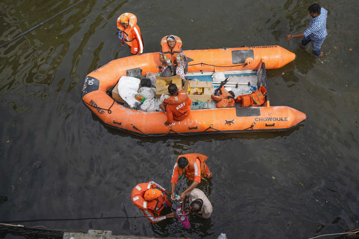Chennai: NDRF personnel distribute food and other items amid floods after heavy rainfall in the aftermath of Cyclone Michaung, in Chennai, Thursday, Dec. 7, 2023. (PTI Photo/ R Senthilkumar)