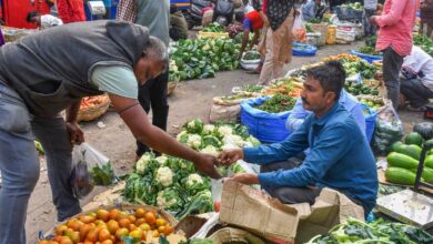 A customer buys vegetables at a market