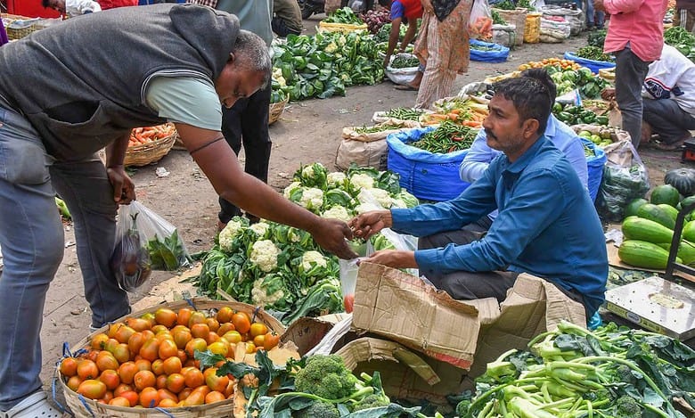 A customer buys vegetables at a market