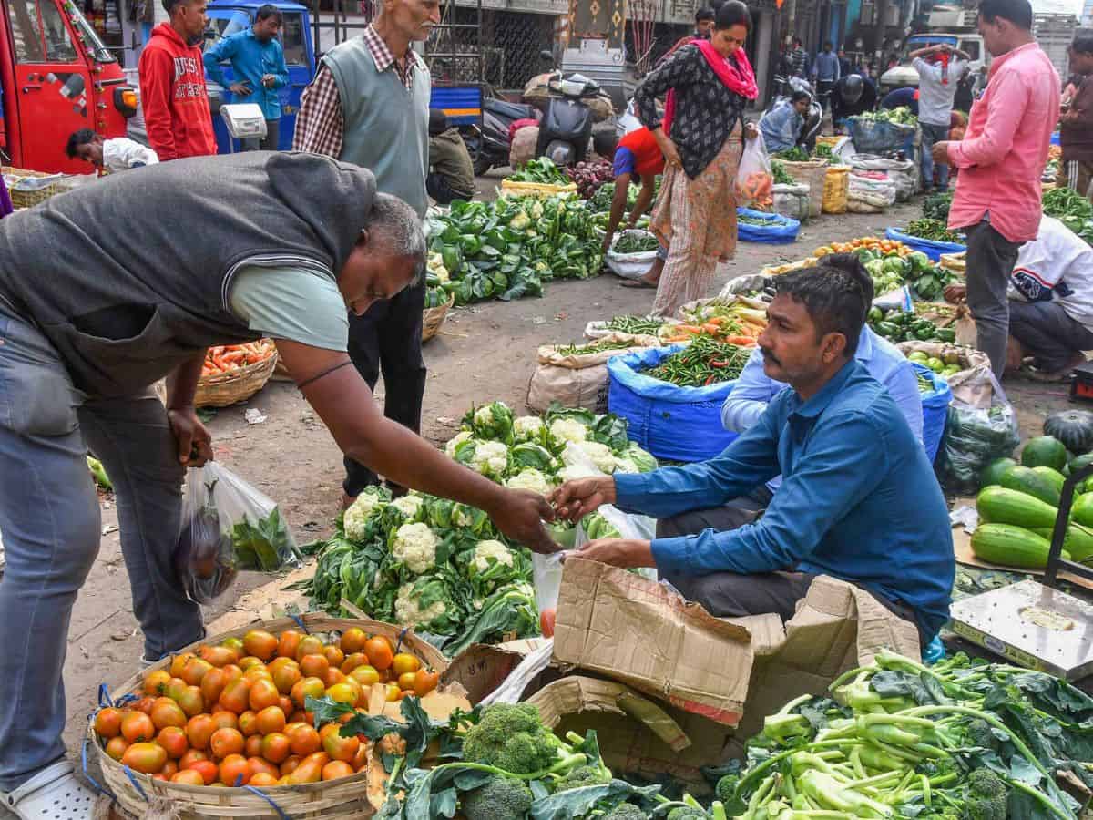 A customer buys vegetables at a market