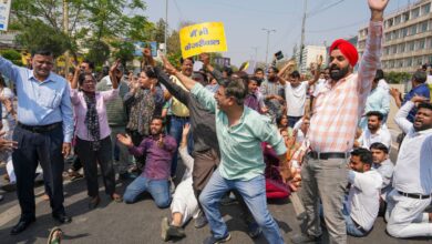 AAP workers block a road during a protest