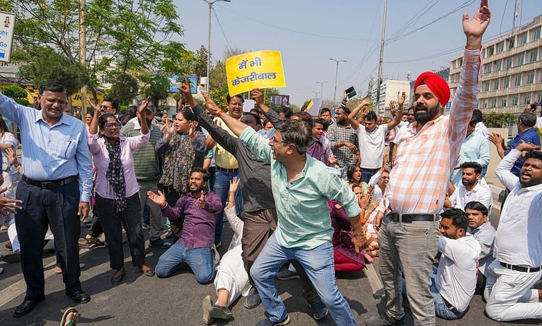 AAP workers block a road during a protest