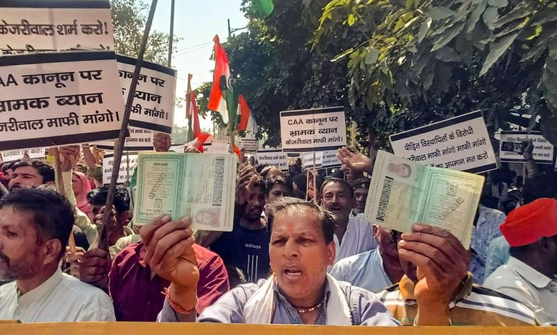 Hindu and Sikh refugees raise slogans during a protest against Delhi Chief Minister Arvind Kejriwal