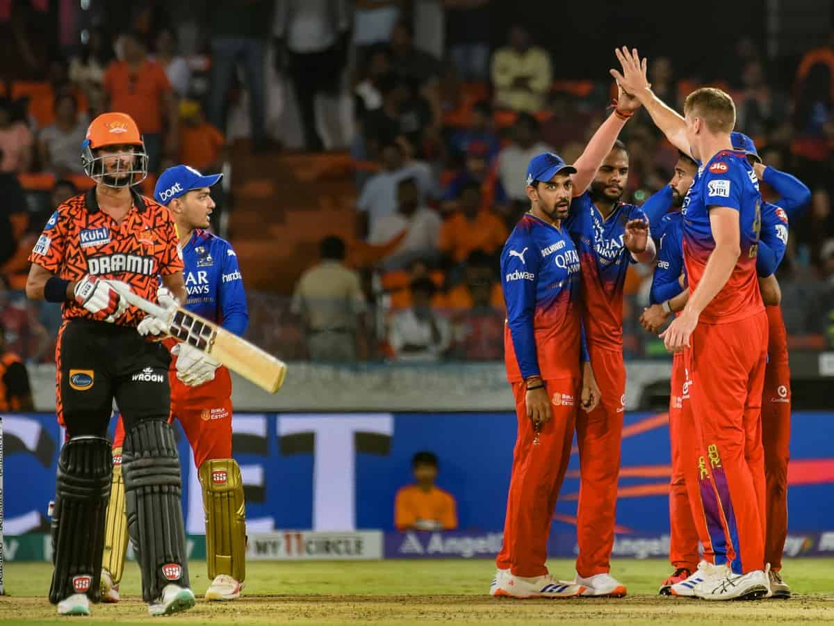 Royal Challengers Bengaluru players celebrate the wicket of Sunrisers Hyderabad batter Bhuvaneshwar Kumar during the Indian Premier League (IPL) 2024 match between Sunrisers Hyderabad and Royal Challengers Bengaluru, at Rajiv Gandhi International Cricket Stadium, in Hyderabad