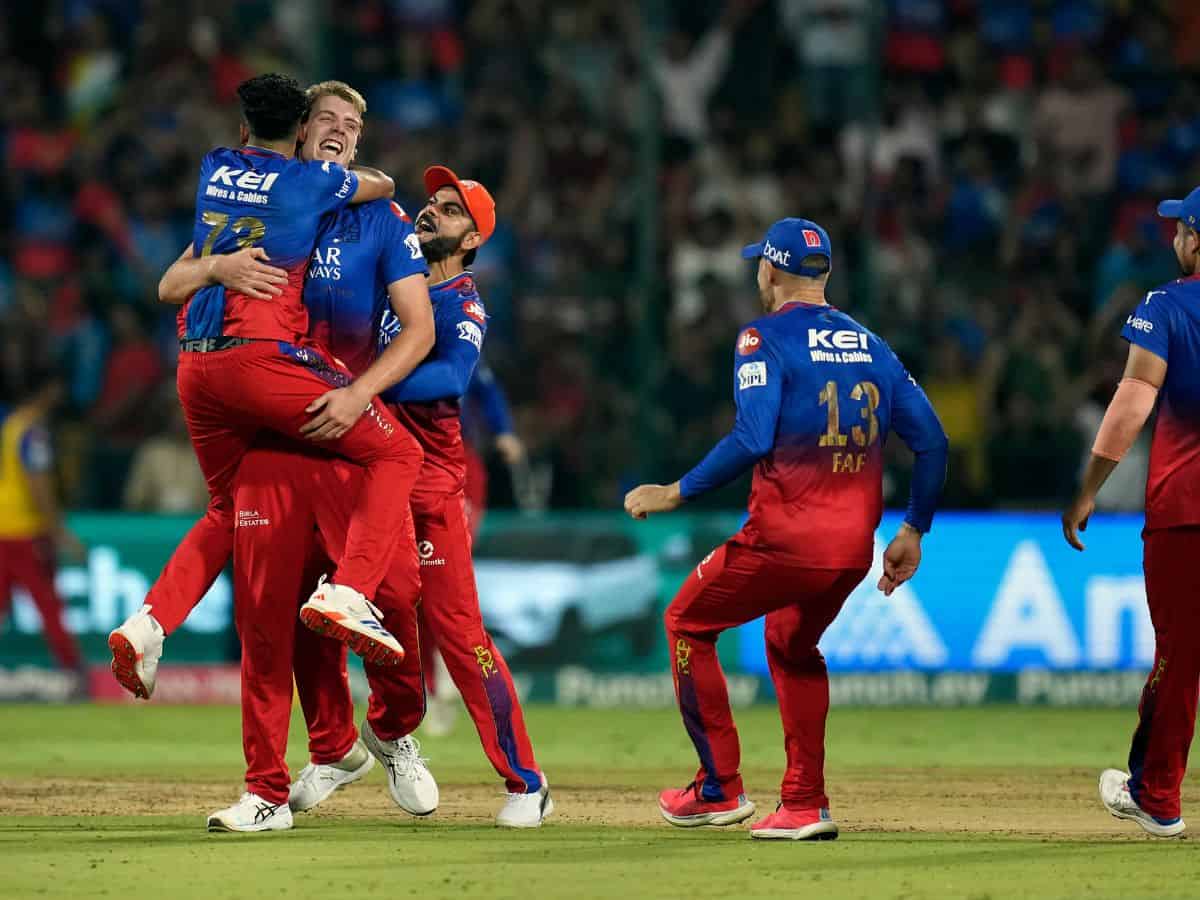 Royal Challengers Bengaluru's Camron Green celebrates with teammates after dismissing Delhi Capitals' Tristan Stubbs through a runout during an Indian Premier League (IPL) 2024 T20 cricket match between Royal Challengers Bengaluru and Delhi Capitals