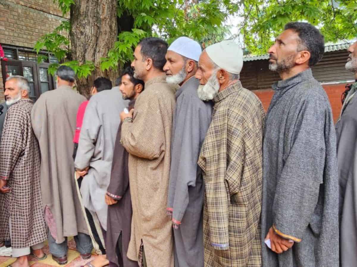 Voters line up outside polling stations in J&K's Srinagar LS seat