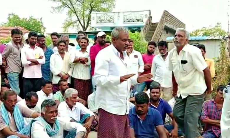 Officials convince villagers who threatened to boycott the elections, to cast their vote.