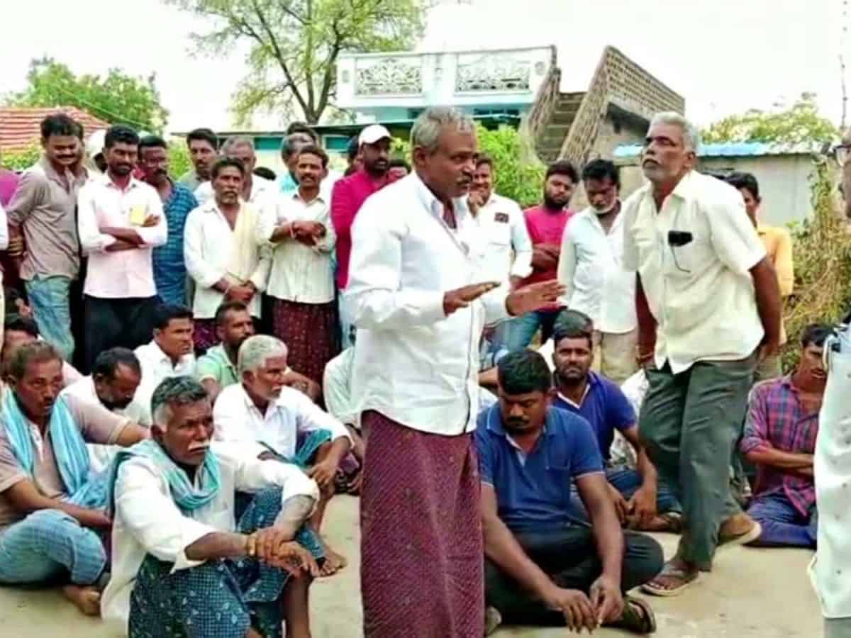 Officials convince villagers who threatened to boycott the elections, to cast their vote.