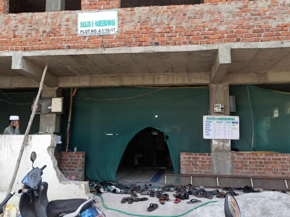 GHMC demolishes the boundary wall of Masjid-e-Habeeb Unnisa located at HMT Maqtha in Miyapur village of Serilingampally mandal using a bulldozer on Tuesday