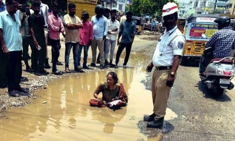 Hyderabad: Nagole woman sits in pothole to protest bad roads