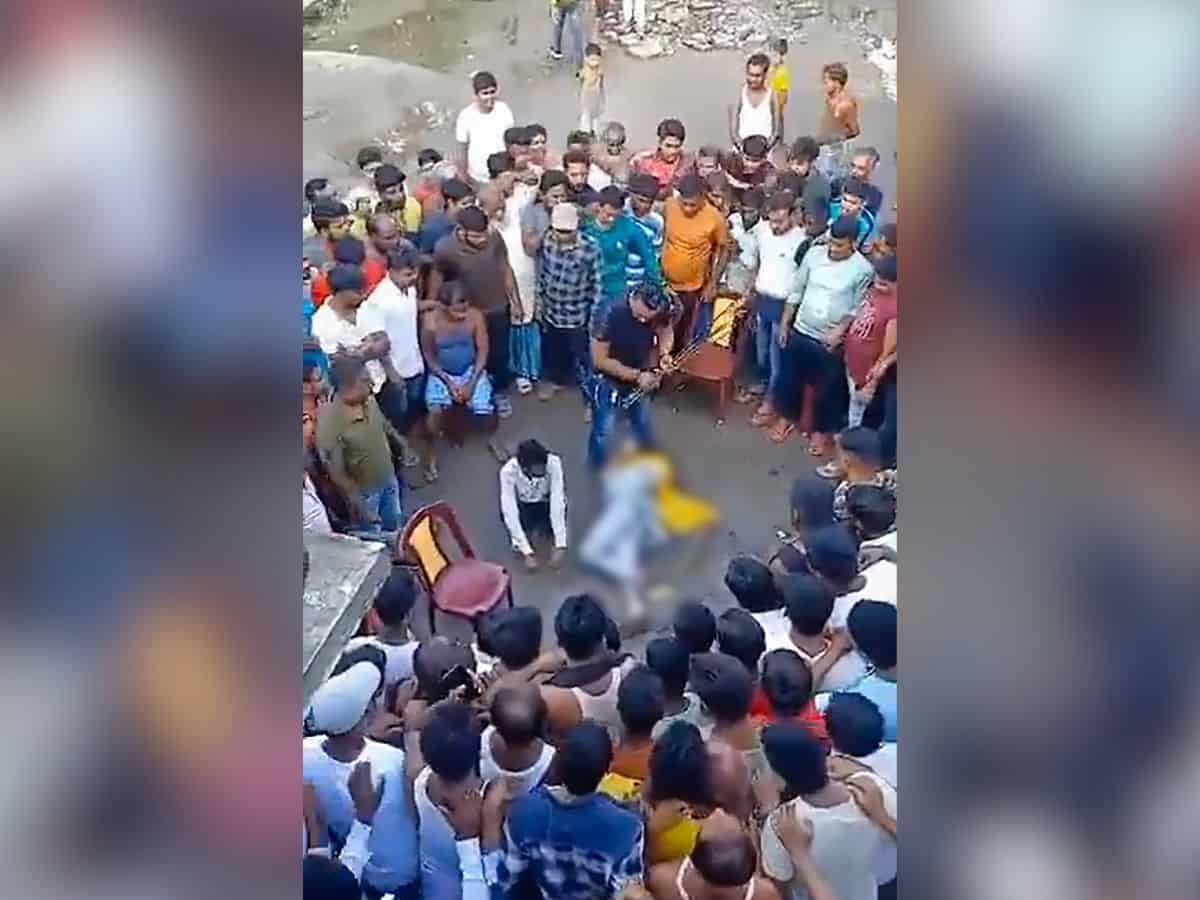 A couple allegedly engaged in an illicit relationship being assaulted by an alleged TMC leader